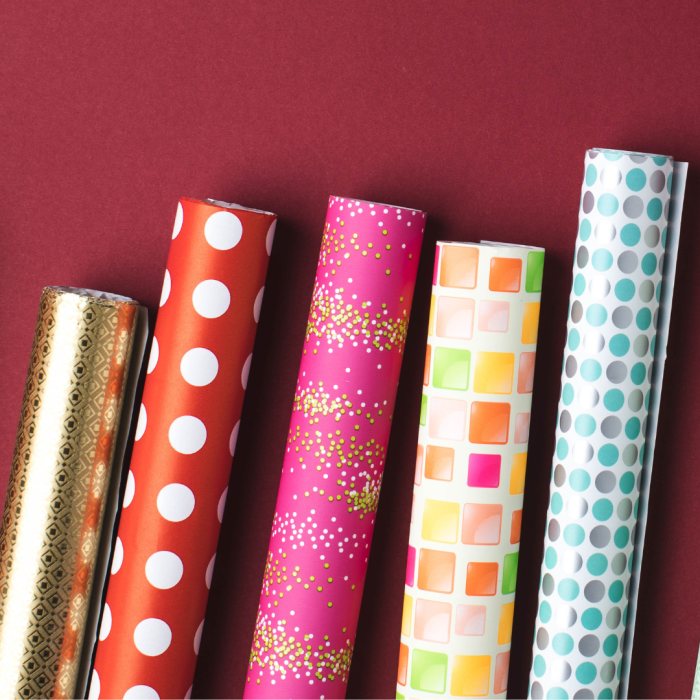 5 rolls of wrapping paper on a red background