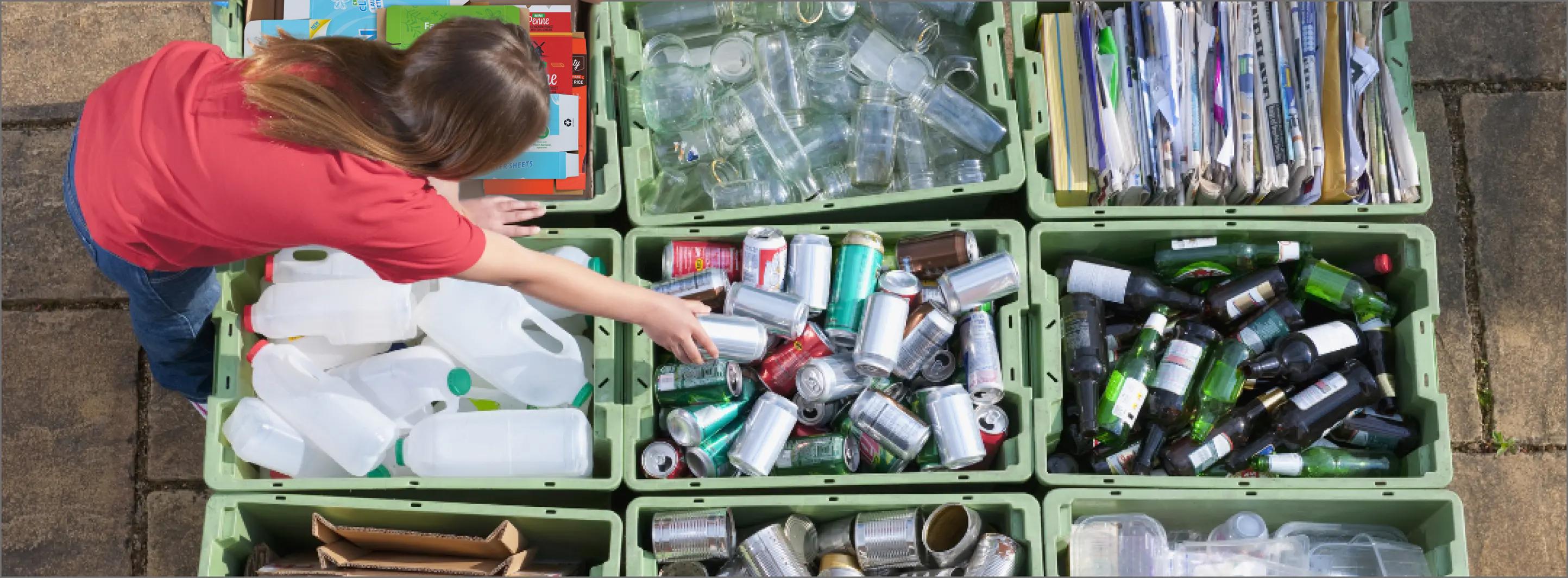 Woman sorting recycling into bins