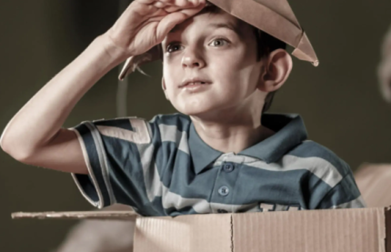 Boy in cardboard box