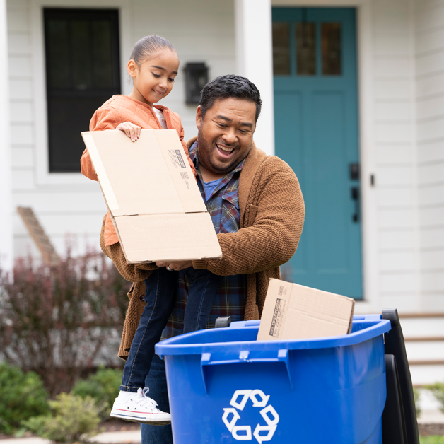 Father and daughter recycling cardboard box