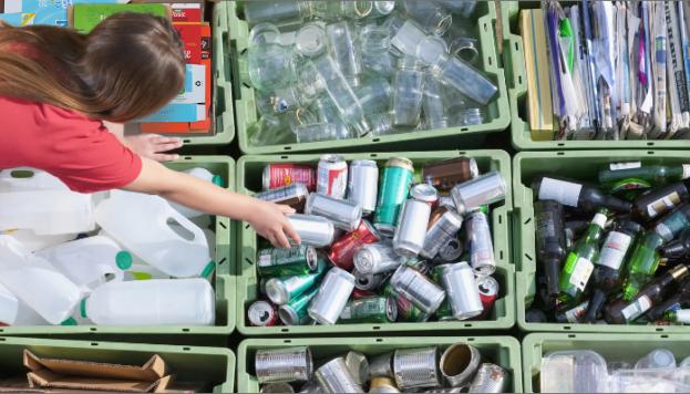 Woman sorting recycling into bins